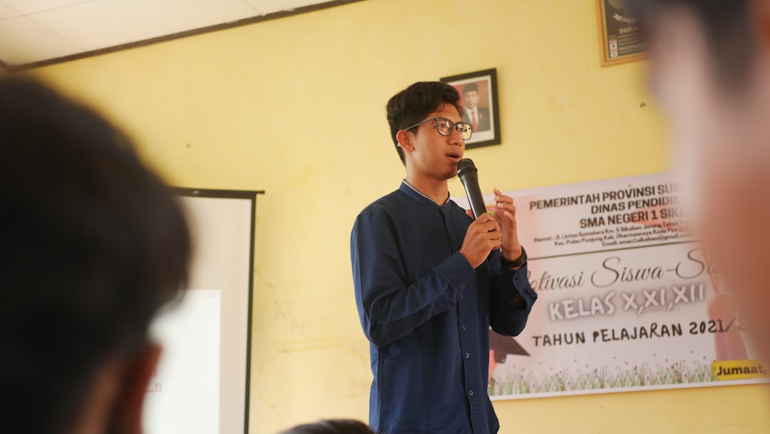 a-man-standing-in-front-of-a-microphone-iw70ffeorn0